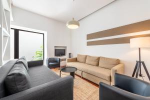a living room with a couch and a tv at GuestReady - Fantastic w Big Patio – Bairro Alto in Lisbon