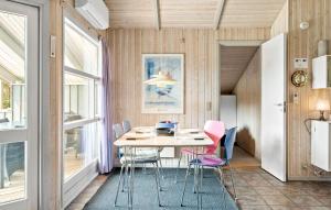 a dining room with a table and chairs at Holiday Home Østersvej Fjerritslev Xii in Slettestrand