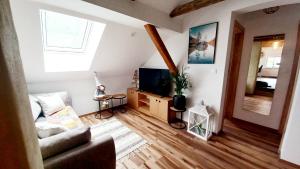 a living room with a couch and a tv at Apartma Rožle in Mojstrana
