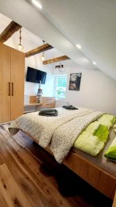 a bedroom with a large bed and a desk at Apartma Rožle in Mojstrana
