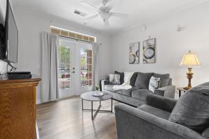 a living room with a couch and a table at Near Disney w/ pool-3BR/2BA-Spacious & Cozy Condo in Davenport