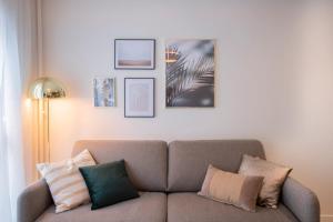 a living room with a couch and pictures on the wall at GuestReady - Apt near Parc de la Villette in Paris