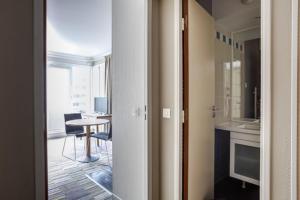 a room with a kitchen and a table with a dining room at GuestReady - Studio near Porte de Versailles Metro in Issy-les-Moulineaux
