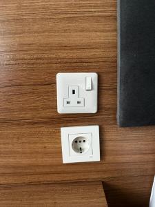 an electrical outlet on a wooden floor next to a wall at Inceli Hotel in Uzungöl