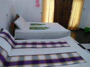 Postel nebo postele na pokoji v ubytování N S K Green Villa
