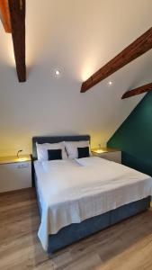 a bedroom with a large bed with white sheets at CHILL&SLEEP Bad Ischl in Bad Ischl