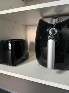 a toaster sitting on a shelf next to a toaster at Eco house 2 in Prestatyn +16 photos