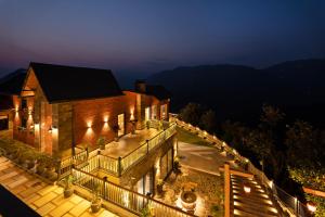 an aerial view of a house at night at SaffronStays Aruunoday - 4BR with Theatre, Deck & Bonfire in Bhīm Tāl