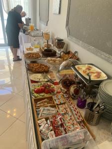 a buffet with many different types of food on a table at Isidora Hotel in Agia Marina Aegina