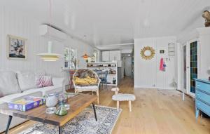 a living room with a couch and a table at Nice Home In Sjællands Odde With Wifi in Yderby