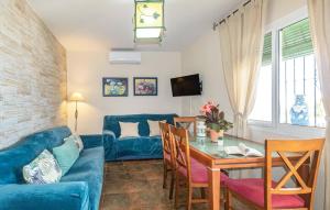 a living room with a blue couch and a table at 2 Bedroom Gorgeous Home In El Morche in Morche