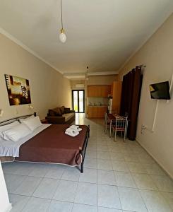 a bedroom with a bed and a living room at Countryside Studios in Ayia Evfimia