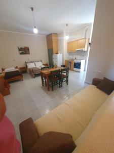 a living room with a couch and a table at Countryside Studios in Ayia Evfimia