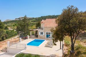 an external view of a house with a swimming pool at Emerald Eco Villa in Novo Selo