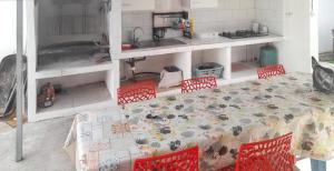 a kitchen with a table and chairs and a kitchen with a table and chairsktop at Maison de 2 chambres a Saint Gilles les Bains a 500 m de la plage avec terrasse amenagee et wifi in Saint-Gilles-les-Bains