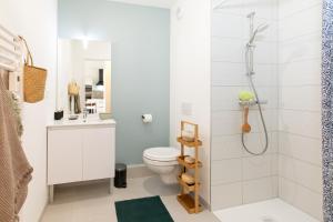 a bathroom with a toilet and a shower at La belle vue in Colmar
