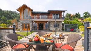 a table with a bowl of fruit on top of a house at SaffronStays Aruunoday - 4BR with Theatre, Deck & Bonfire in Bhīm Tāl +49 photos
