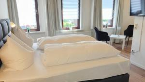 מיטה או מיטות בחדר ב-Hotel Schneiderhof