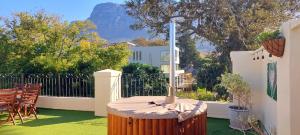 um grande barril de madeira com um termómetro num quintal em Riversong Guest House na Cidade do Cabo