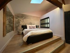Un pat sau paturi într-o cameră la Le St Vincent