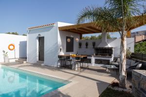 a backyard with a swimming pool and a villa at Villa Stavelia in Gouves