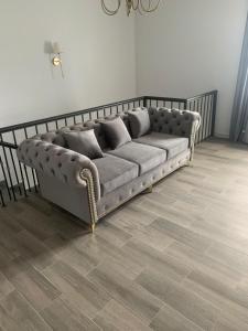 New house in Jrvezh في يريفان: أريكة في غرفة معيشة مع أرضية خشبية