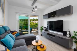 a living room with a couch and a tv at Vista Verde in Dubrovnik