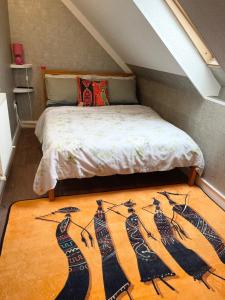 a bedroom with a bed with a rug on the floor at Crescent Loft Apartment - 1 Bedroom in Goodmayes