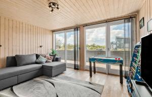 a living room with a couch and a pool table at Amazing Home In Tarm With Kitchen in Tarm