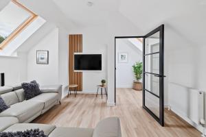 a living room with a couch and a mirror at Corn Flour Lodge - Pitkerro Mill in Dundee
