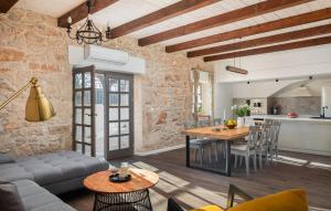 a living room with a table and a kitchen at Lovely Home In Dubrava Kod Sibenika in Protega