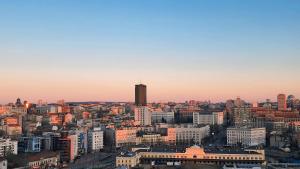 a cityscape of a city at sunset at Belgrade Waterfront 16th fl Lux Apt. w/ City view in Belgrade