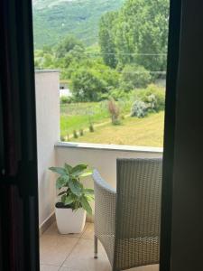 a porch with a potted plant and a window at Grand Park Hotel in Gjirokastër +10 photos
