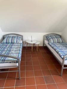 a room with two beds and a table and a table at Ferienwohnung Hohwacht Ostsee in Hohwacht +9 photos