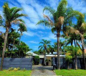 a house with palm trees in front of it at Kennington Palms B&B/Self Catering in East London