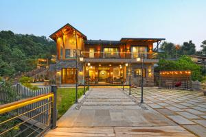 a house with a walkway in front of it at SaffronStays Aruunoday - Villa 4 bhk and 1 room Suite in Bhīm Tāl