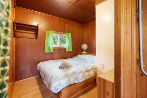 a bed in a small room with a window at Enjoy The Outdoors at Rice Lakes in Bailieboro