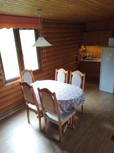 a kitchen with a table and chairs in a room at Закарпатский сруб in Krasna