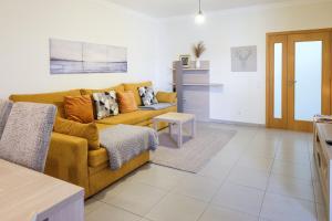a living room with a couch and a table at Casa Formosa - Tavira in Tavira