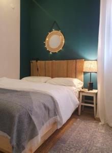 a bedroom with a bed with a mirror on the wall at The Turquoise Suite on the Sea Trail, Atlit in Atlit +33 photos
