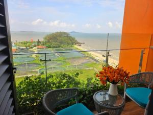a balcony with a view of the ocean at Flamingo Hải Tiến in Thanh Hóa