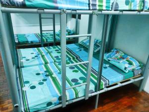 a couple of bunk beds in a room at Mang Ben Dormitory Kaliraya in Manila
