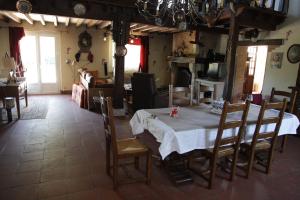 a dining room with a table and chairs at La Grange in Vouzon