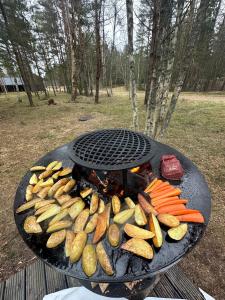a grill with a bunch of vegetables on it at The Lighthouse in Pāvilosta
