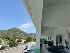 a view of the mountains from the balcony of a house at Papaya Inn in Oranjestad