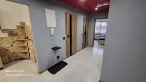 a room with a hallway with white walls and a door at Apatament LISEK in Lisów