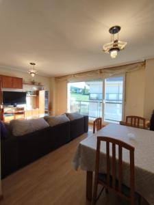 a living room with a couch and a table at El Mirador De La Sierra in Piedrahita