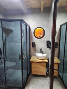 a bathroom with a sink and a shower at Heyamoo Tatil Köyü in Çamlıhemşin +7 photos