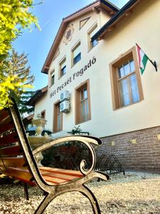 a bench sitting in front of a building at Hét Pecsét Fogadó Étterem in Sopron