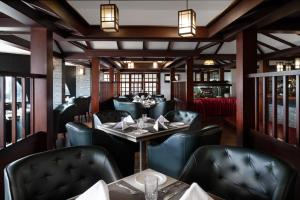 a restaurant with tables and chairs in a room at Presidency Towers,Kochi in Cochin